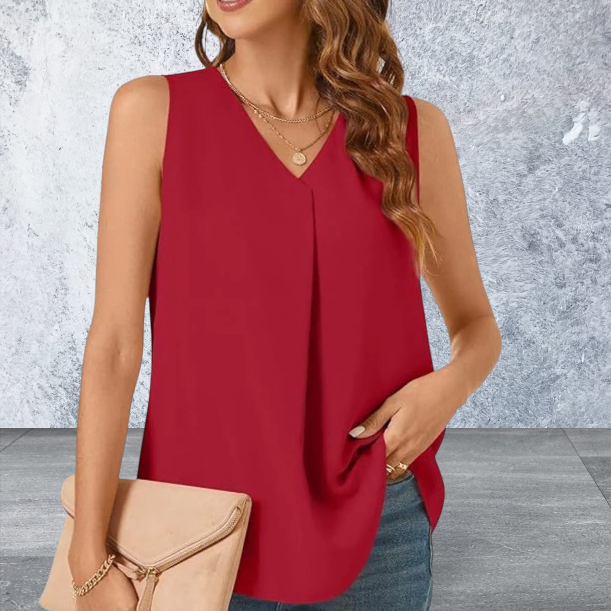 Woman wearing a red sleeveless top with a neutral background