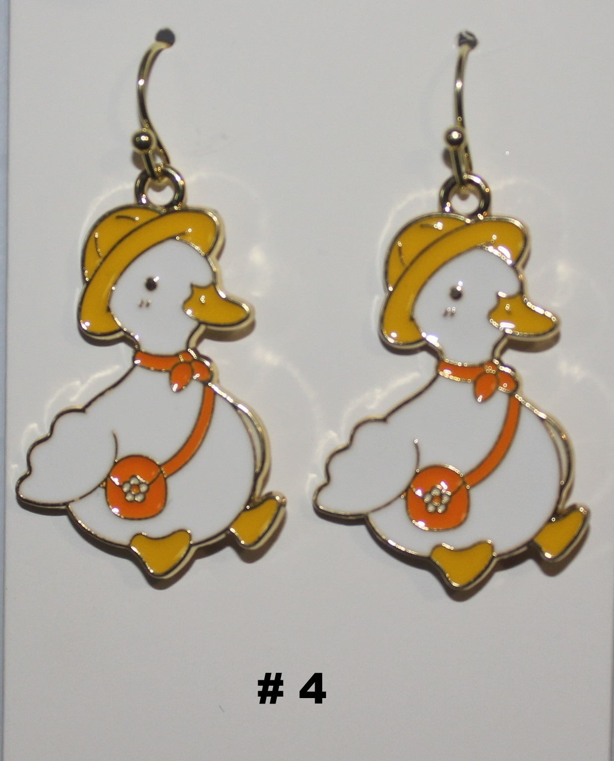 Duck-shaped earrings with a yellow hat and orange bag