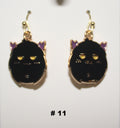 Black cat-shaped handmade earrings with gold accents 