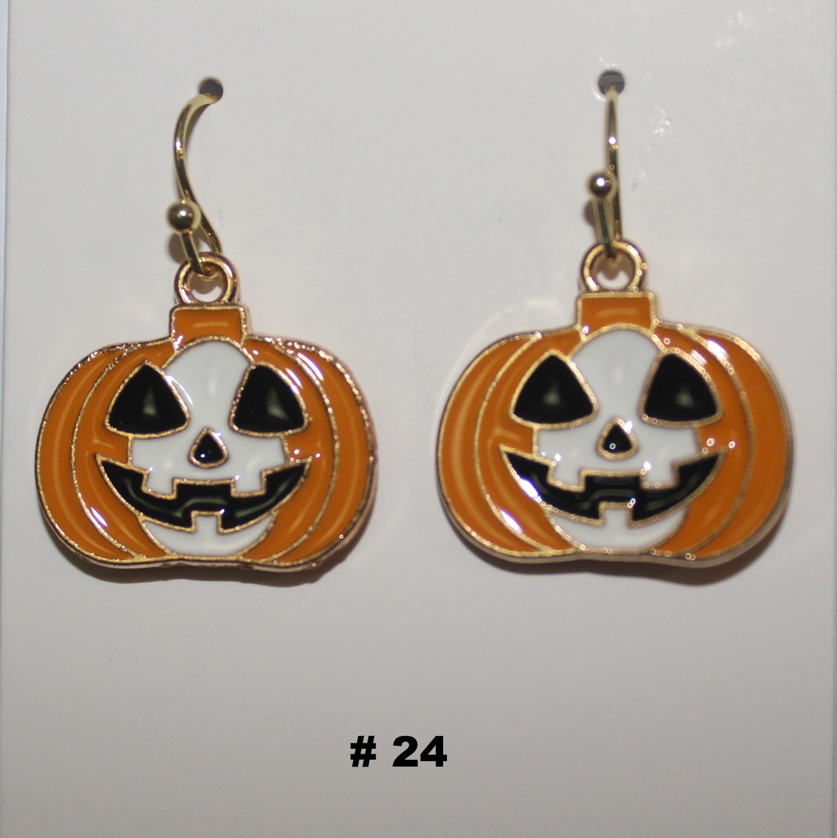 Halloween-themed pumpkin earrings with jack-o'-lantern faces 