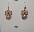 Butterfly-shaped earrings with pearl center
