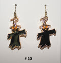 Halloween-themed earrings with black figures and orange accents 
