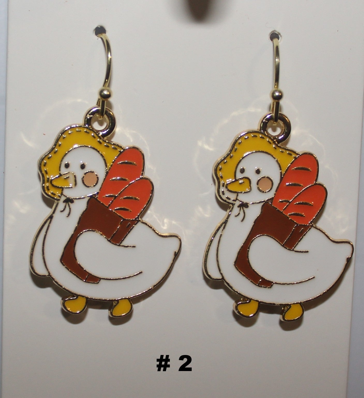 Pair of duck shaped earrings with bread