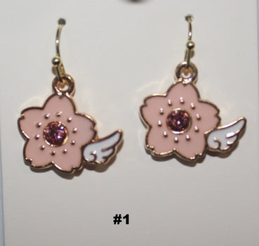 Flower-shaped earrings with pink petals and a central gemstone 