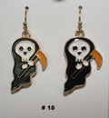Pair of ghost-shaped earrings with a white face and black body