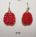 Pair of red handmade earrings with gold accents