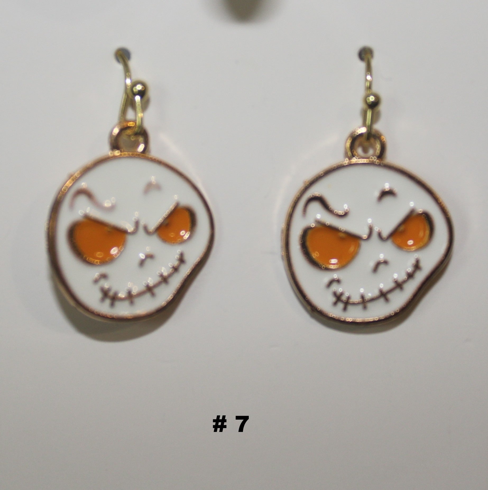 Pair of handmade ghost head earrings with skull design 