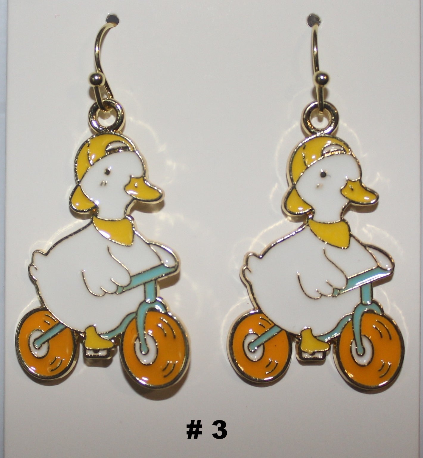 Pair of duck riding bikes earrings