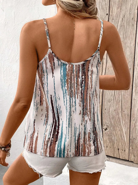 Woman wearing a colorful striped tank top and white shorts against a wooden wall.