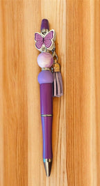 Red pen with butterfly charm and tassel