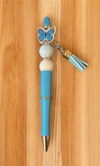 Red pen with butterfly charm and tassel