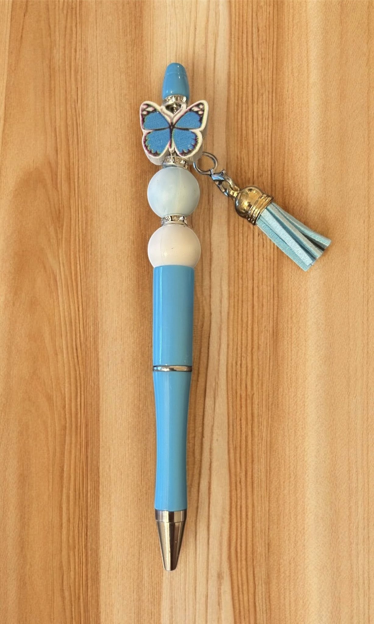 Red pen with butterfly charm and tassel