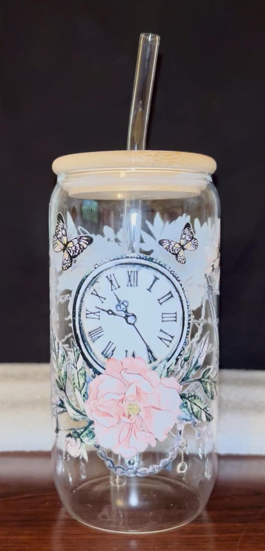 Glass jar tumbler with decorative clock and floral design 