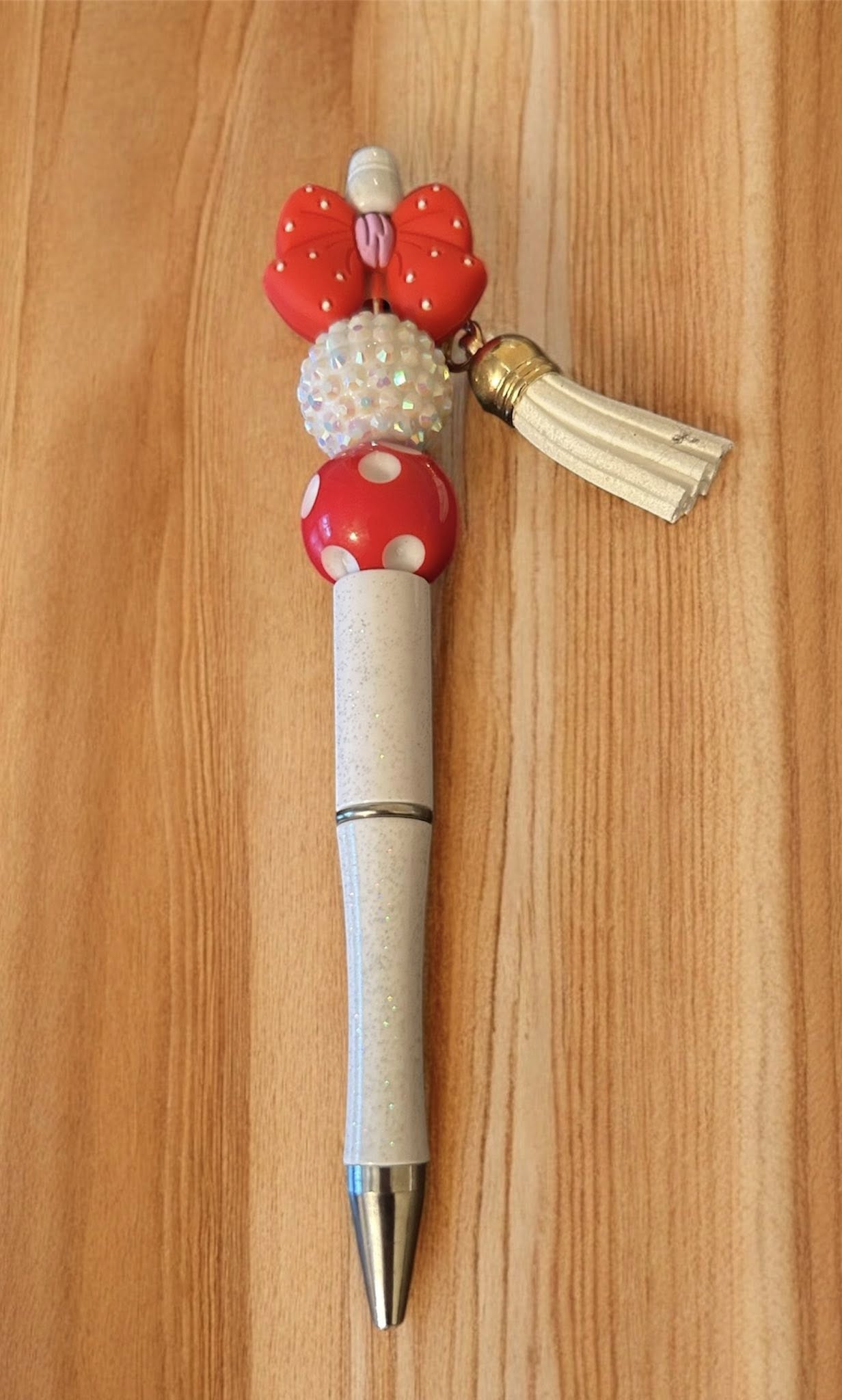Decorative pen with red and white accents 