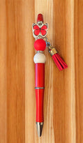 Red pen with butterfly charm and tassel 