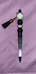 Decorative pen with beads and a tassel 