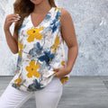 Woman wearing a sleeveless floral top with yellow and blue flowers 