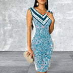 Woman wearing a blue patterned dress against a gray textured wall.