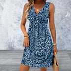 Woman wearing a blue leopard print dress against a gray background