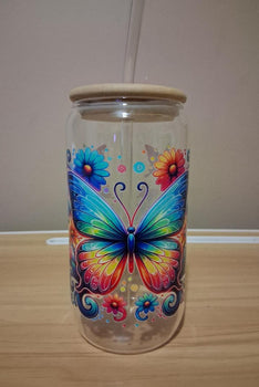 Glass tumbler with a colorful butterfly design 