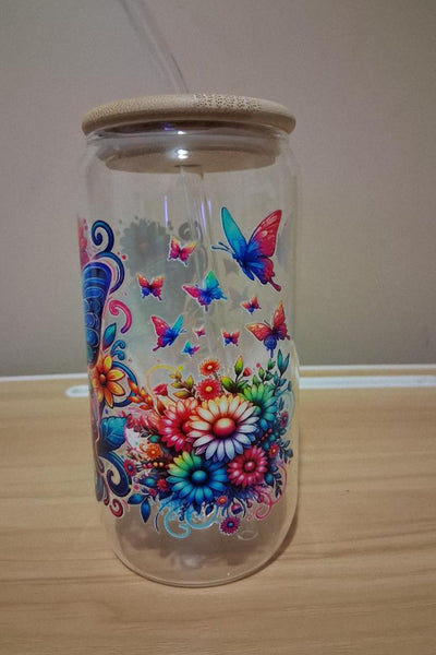 Glass tumbler with a colorful butterfly design 