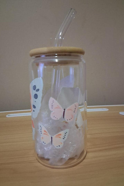 Clear glass jar with butterfly designs, wooden lid and straw 