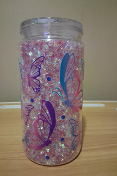 Clear tumbler with butterfly designs and pink glitter 
