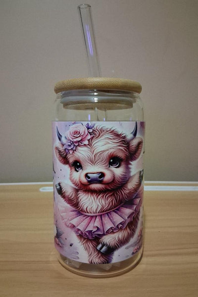 Glass jar with a straw lid featuring a cute animal illustration 