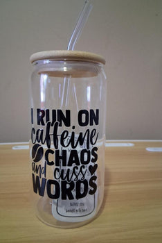 Clear tumbler with wooden lid and straw featuring text 