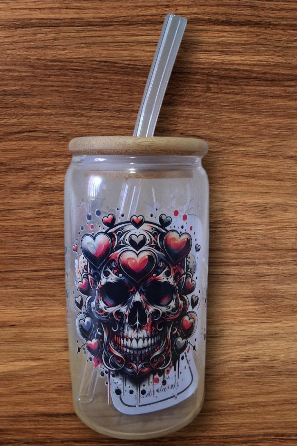 Glass cup with skull designs all around