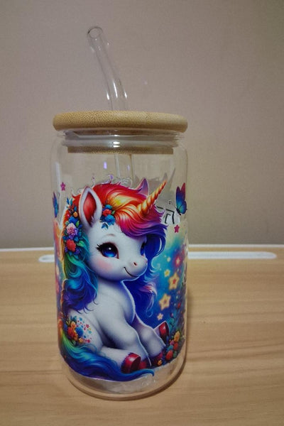 Glass cup with a colorful unicorn design 