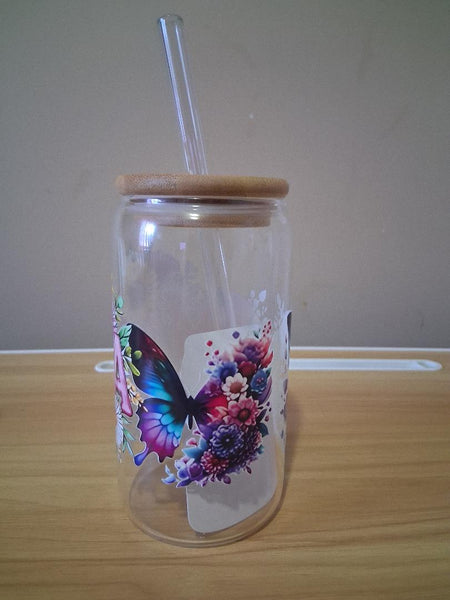 Clear tumbler with butterfly design, wooden lid, and glass straw 